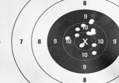Black and white, Close up of a shooting target and bullseye with bullet holes